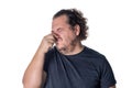 A young man holds or pinches his nose shut because of a stinky smell or odor