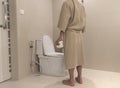 Young man holds a roll of toilet paper Going to the bathroom Royalty Free Stock Photo