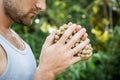 Young man holds a rosary in his hands and pray Royalty Free Stock Photo