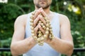 Young man holds a rosary in his hands and pray Royalty Free Stock Photo