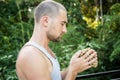 Young man holds a rosary in his hands and pray Royalty Free Stock Photo