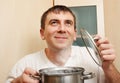 Young man holds a saucepan Royalty Free Stock Photo