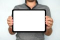 Young man holds a touch pad tablet on isolated white background. Large-size digital tablet with white screen is held by