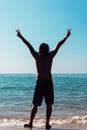 Young Man Holds Up Peace Sign, Towards Clouds