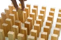 Young man holds the wood block in his hand to put it into the row Royalty Free Stock Photo