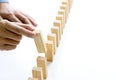 Young man holds the wood block in his hand to put it into the row Royalty Free Stock Photo