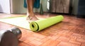 Young man at home arranging yoga mat before starting exercise - Concept of medical, helathcare, Fitness.