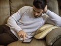 Young man at home reading with ebook reader Royalty Free Stock Photo