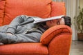 Young man at home sleeping instead of working or