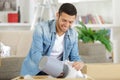 young man in home unpacking lamp from carboard box Royalty Free Stock Photo