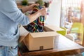 Man at home unpacking parcel with clothing Royalty Free Stock Photo