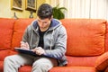 Young man at home writing on notebook Royalty Free Stock Photo