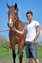 Young man and horse Royalty Free Stock Photo