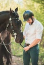 Young man with horse. Autumn outdoors scene Royalty Free Stock Photo