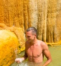 A young man in a hot mineral spring. Turkey. Karahayit near the Royalty Free Stock Photo