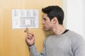 Young man in hotel pointing at floorplan