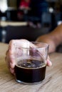 Young man with an iced coffee in a coffeehouse