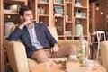 Young man indoors sitting interior coffee bar Royalty Free Stock Photo