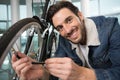 young man inflates bicycle wheel using pump Royalty Free Stock Photo