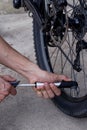 The young man inflates bicycle wheel Royalty Free Stock Photo