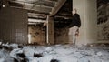 Young man inside ruined and abandoned old factory interior Royalty Free Stock Photo