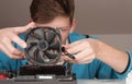 Young man installing CPU cooler fan on gaming motherboard Royalty Free Stock Photo