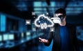 Young Man Using Virtual Reality Headset with Cloud Icons and Digital Data in Background of Modern Network and Computing Royalty Free Stock Photo