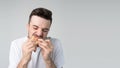 Young man isolated over background.Biting and chewing tasty delicious burger alone in studio. Pleasure taste. Yummy food Royalty Free Stock Photo