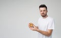 Young man isolated over background. Unhappy sad guy hold opened burger and look on camera. Unfresh, terrible taste and Royalty Free Stock Photo
