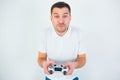 Young man isolated over white background. Guy hold joystick in hands and play computer game. Concentrated on playing. Royalty Free Stock Photo