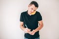 Young man  over white background. Guy using banana as smartphone and pretent to talk on it. Writing down notes Royalty Free Stock Photo