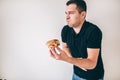 Young man isolated over white background. Sick guy suffer from vomit because of bad unhealthy unfresh burger. Almost Royalty Free Stock Photo
