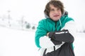 Young man in jacket shivering in snow