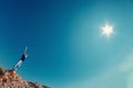 Young man in jeans and black shirt on a mountain raised their h Royalty Free Stock Photo