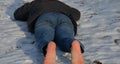 Young man in jeans running away barefoot in the snow. Detained by police lying on the ground with his hands behind his back, no sh