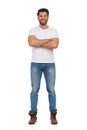 Young Man In Jeans And White T-shirt Is Standing With Arms Crossed Royalty Free Stock Photo