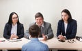 Young man during job interview and members of managemen Royalty Free Stock Photo