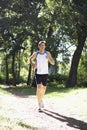 Young Man Jogging Through Woodland Royalty Free Stock Photo