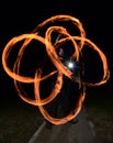 Young man juggling fire poi