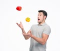 Young man juggling pepper Royalty Free Stock Photo