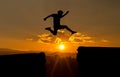 A young man jump between 2017 and 2018 years over the sun and through on the gap of hill silhouette evening colorful sky. Royalty Free Stock Photo