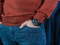 Makhachkala, Dagestan, RUS, October 10, 2019 Young man in a jumper and jeans demonstrates a large wristwatch