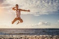 Young man jumping on beach Royalty Free Stock Photo