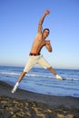 Young man jumping on the blue beach Royalty Free Stock Photo