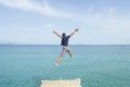 Young man jumping from the dock into the sea Royalty Free Stock Photo