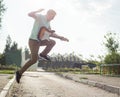 Young man jumping with a guitar on background of sky Royalty Free Stock Photo