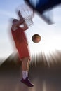 Young man jumping and making a fantastic slam dunk playing stree Royalty Free Stock Photo