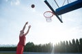 Young man jumping and making a fantastic slam dunk playing stree Royalty Free Stock Photo