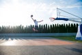 Young man jumping and making a fantastic slam dunk playing stree Royalty Free Stock Photo