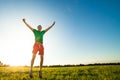 Young man jumping on meadow with dandelions Royalty Free Stock Photo